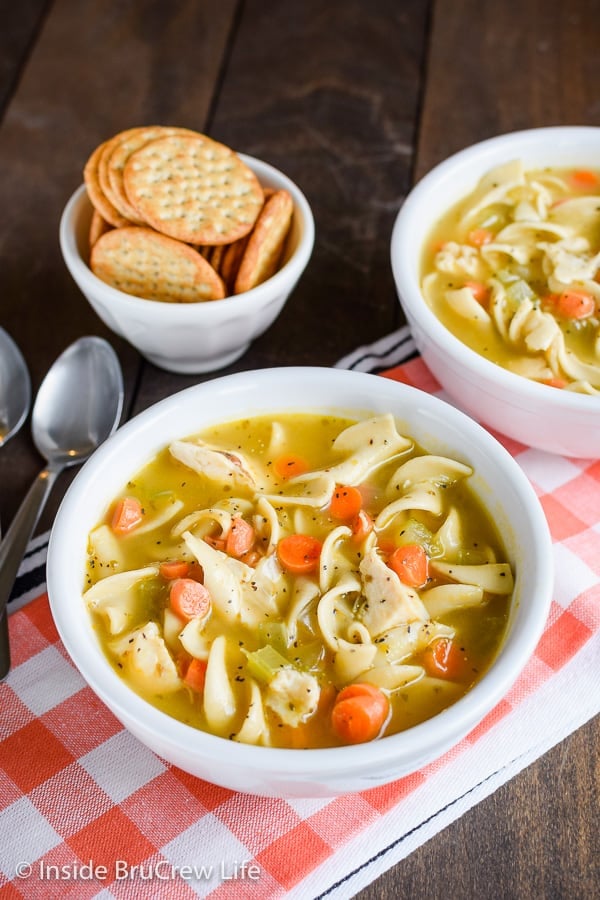 A white bowl filled with homemade chicken noodle soup.