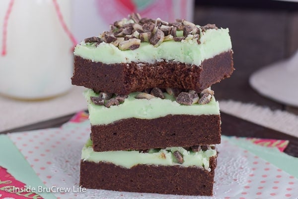 A stack of three chocolate mint sugar cookie bars on a white doily