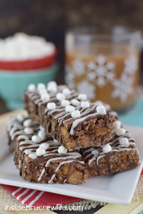 A white plate with three salted caramel hot chocolate granola bars stacked on it