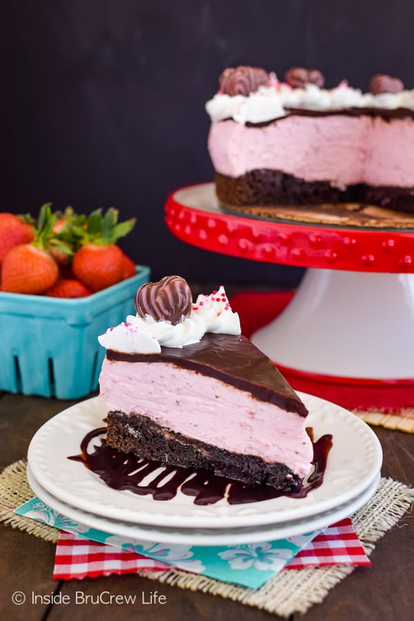 A white plate with a pink and chocolate dessert on it.