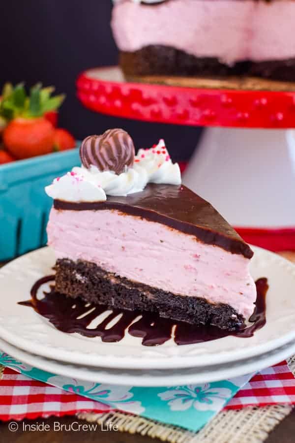 A white plate with a chocolate and strawberry dessert on it.