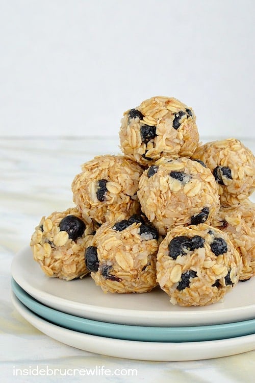 A plate with blueberry coconut granola bites stacked on it