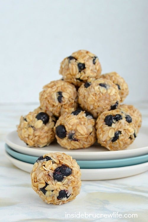 A plate of blueberry coconut granola bites with one bite in front of the plate