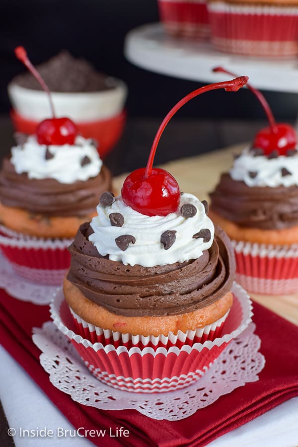 Cherry Chocolate Chip Cupcakes - two swirls of frosting, cherries, and chocolate chips make these easy cupcakes look like they came from a bakery! #cupcakes #cakemix #doctoredupcakemix #cherry #chocolate