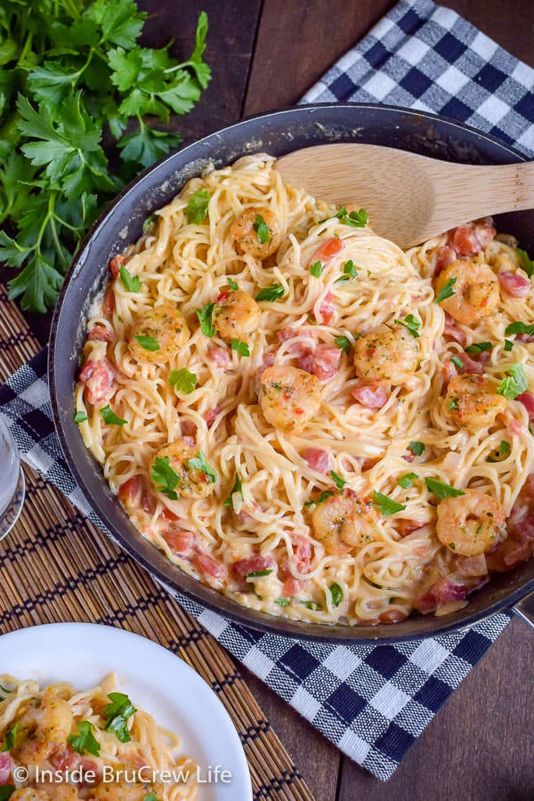 Spicy Parmesan Shrimp Scampi - pasta and shrimp in a homemade cheese sauce is an easy and delicious skillet meal. Make this comfort food recipe in under 30 minutes. #pasta #shrimp #shrimpscampi #easyrecipe #parmesan