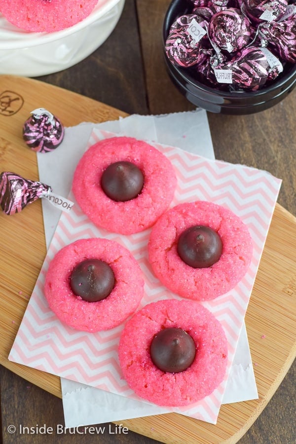 Overhead picture of four pink cookies topped with chocolate kisses.