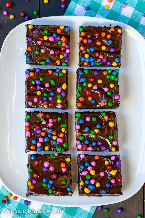 An overhead picture of chocolate brownies covered in rainbow chips.