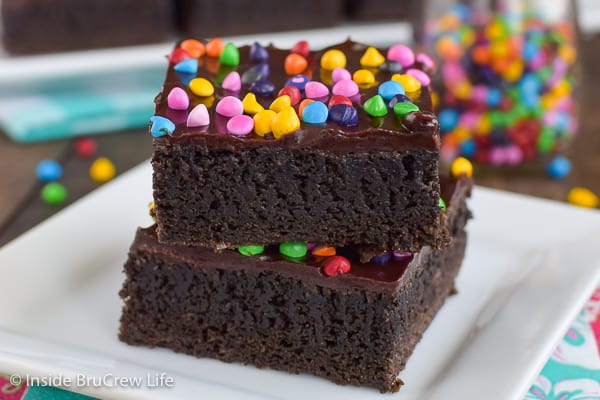 Frosted Rainbow Chip Brownies - homemade brownies with dark chocolate frosting and rainbow chip sprinkles are the perfect copycat for cosmic brownies. Make this easy recipe for bake sales or lunch box treats.