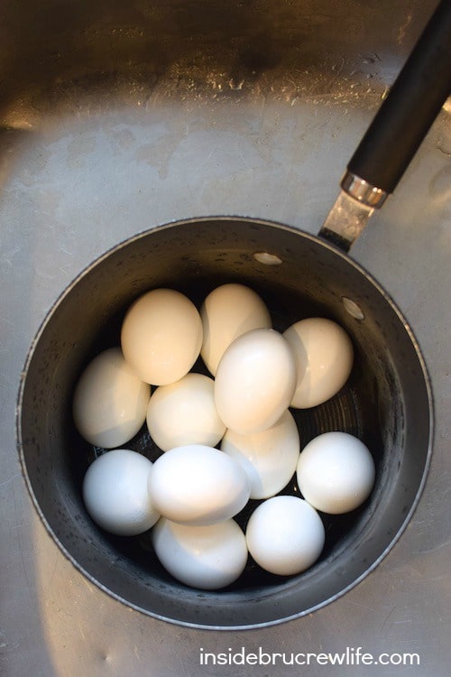 A pan full of hard boiled eggs.