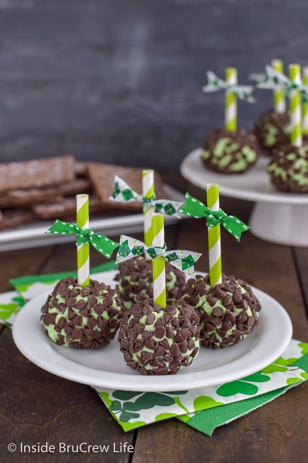 Green mint cream cheese balls covered in mini chocolate chips on a white plate.