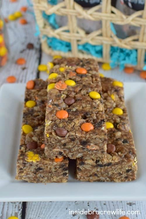 Three peanut butter cookies and cream granola bars stacked on a white plate