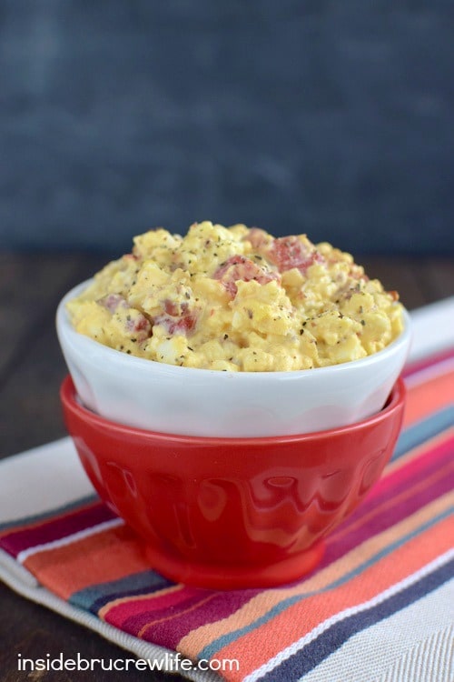 A bowl of egg salad on a towel.