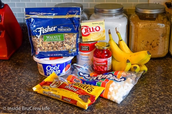 Banana Split Fluff Salad ingredients on a dark counter