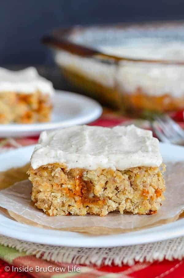 Frosted Cinnamon Apple Bars - shredded apples, cinnamon chips, and a creamy cinnamon frosting makes these easy oatmeal bars a must make. Try this easy recipe for fall parties! #apple #oatmealbars #cinnamon #frosting #fall