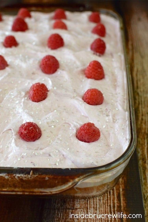 This vanilla hazelnut poke cake topped with a marshmallow raspberry topping is a cool and refreshing dessert. Perfect of those hot summer months!