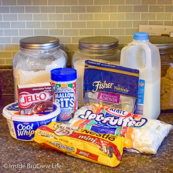 All the ingredients to make Rocky Road Fluff Salad on a dark counter