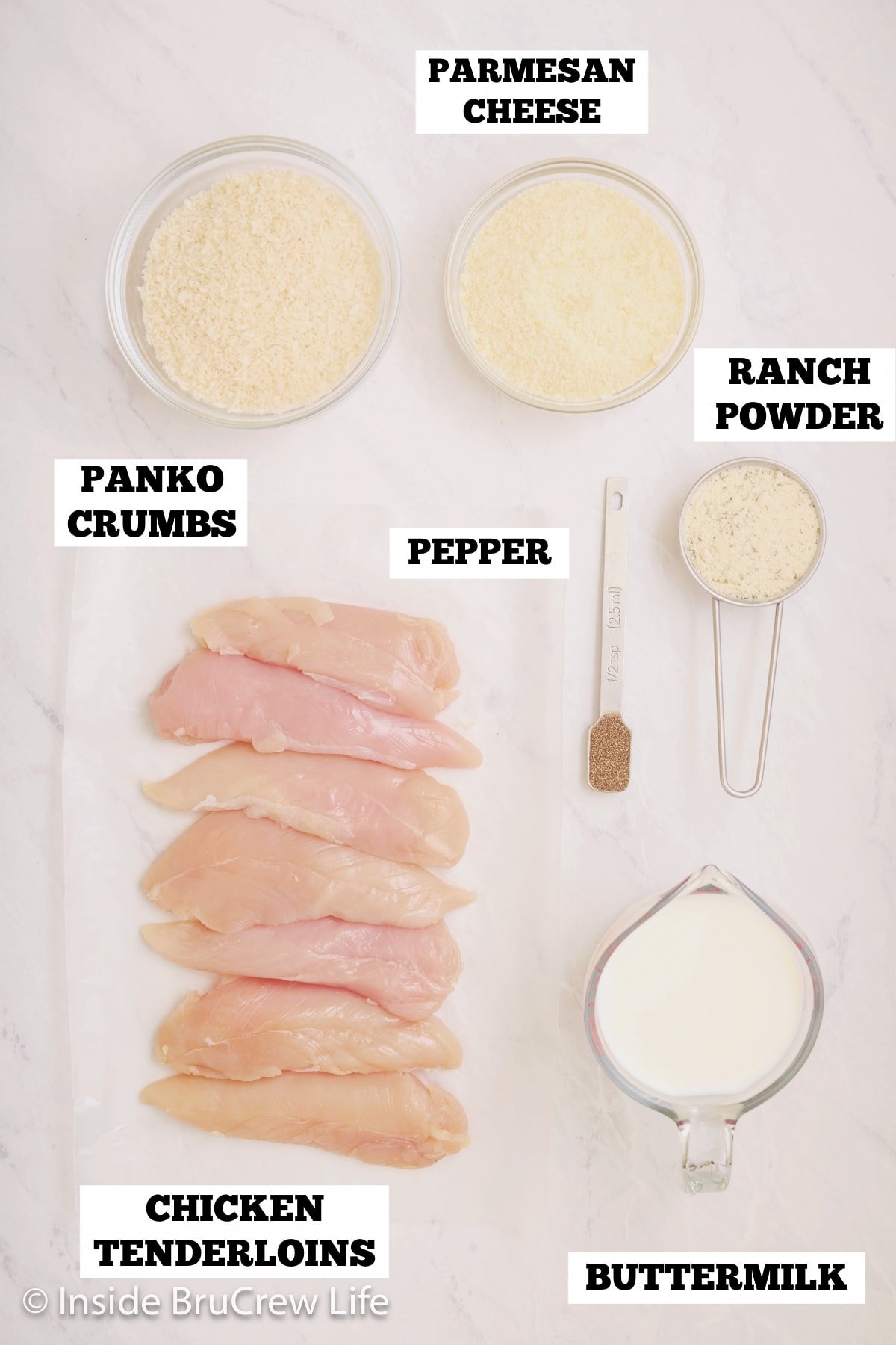 A white board with ingredients needed to make baked chicken strips on it.