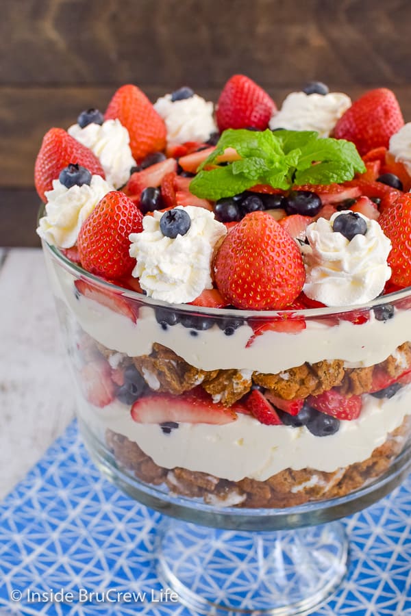 A clear glass dish filled with a berry trifle made from oatmeal cream pies, fresh fruit, and no bake cheesecake
