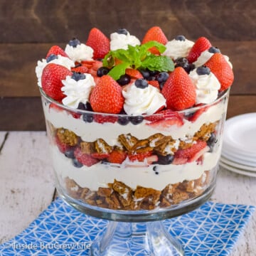 A clear dish filled with a berry trifle made from oatmeal cream pies, fresh fruit, and no bake cheesecake