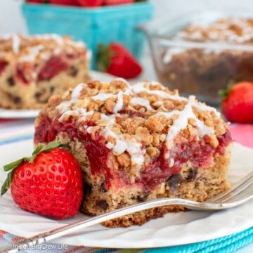A white plate with a square of strawberry banana coffee cake on it.