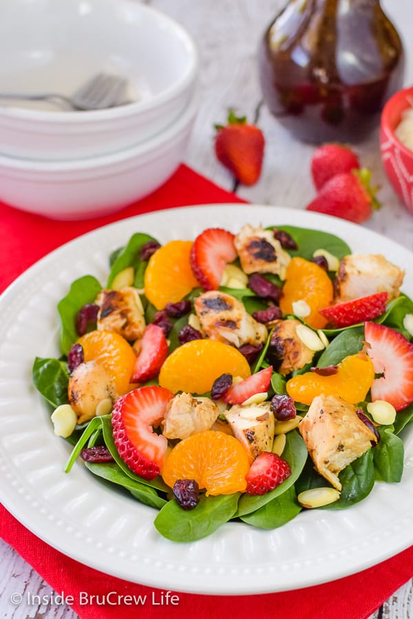 Strawberry Orange Spinach Salad - add your favorite fruits, nuts, and cheese to this easy spinach salad! Great recipe to make for the hot summer months! #salad #strawberry #spinach #healthy #grilledchicken