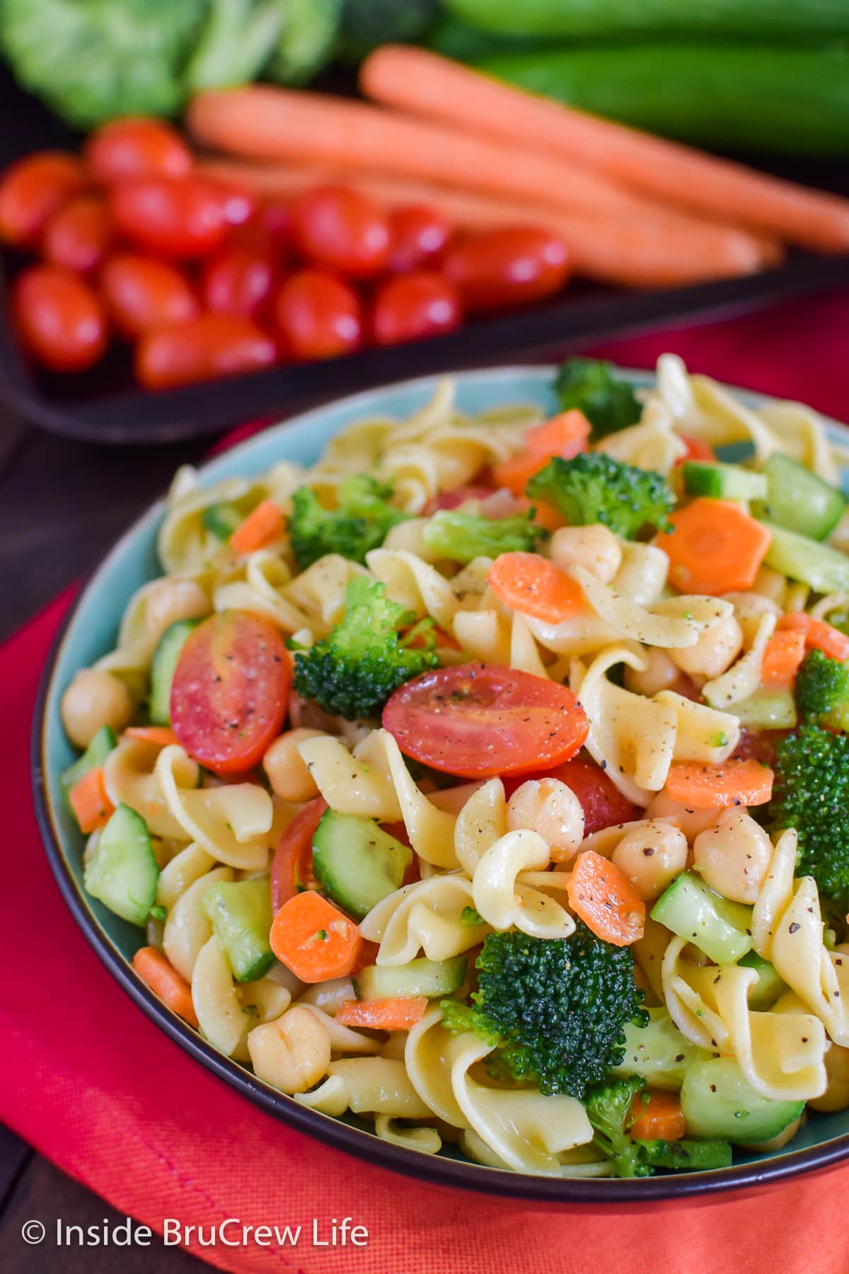 A large bowl filled with egg noodles and veggies.
