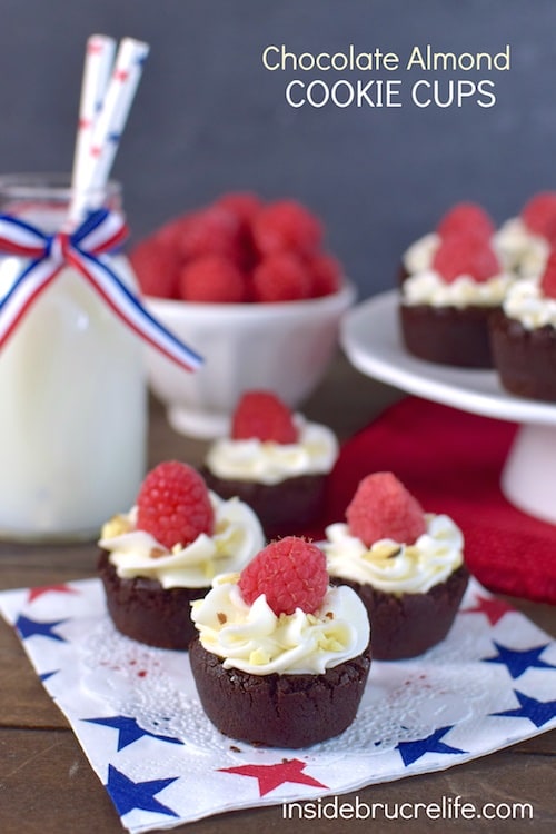 These little chocolate cookie cups are filled with almond frosting and have a fresh raspberry on top.