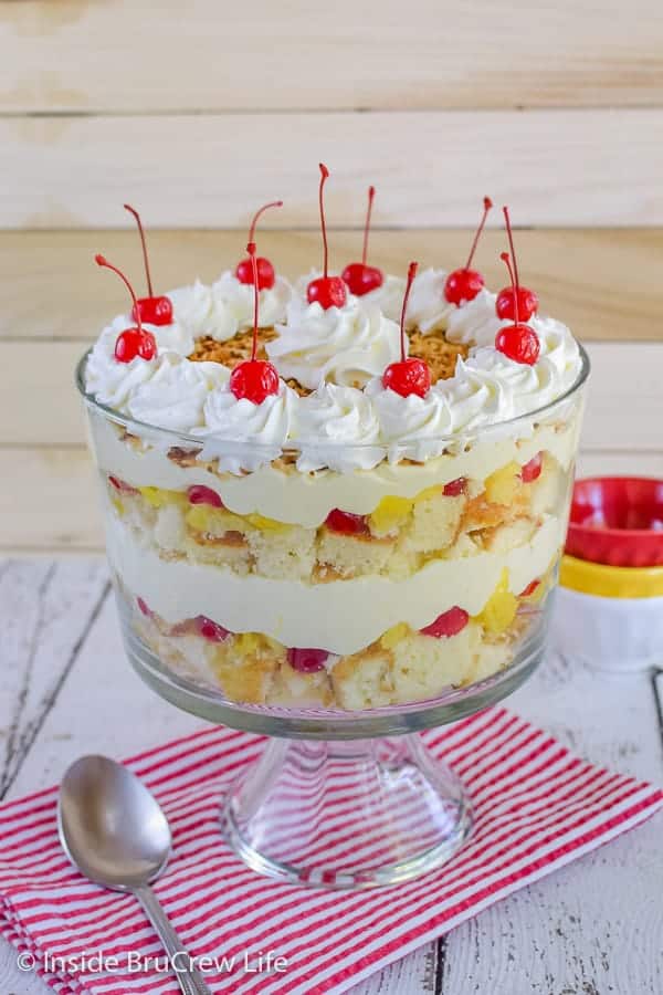 Pina Colada Cake Trifle - this easy cake trifle has layers of pineapple cake, no bake coconut cheesecake, and fruit. Easy recipe to make for summer parties and picnics! #pinacolada #coconut #trifle #nobakecheesecake #cakemix #caketrifle