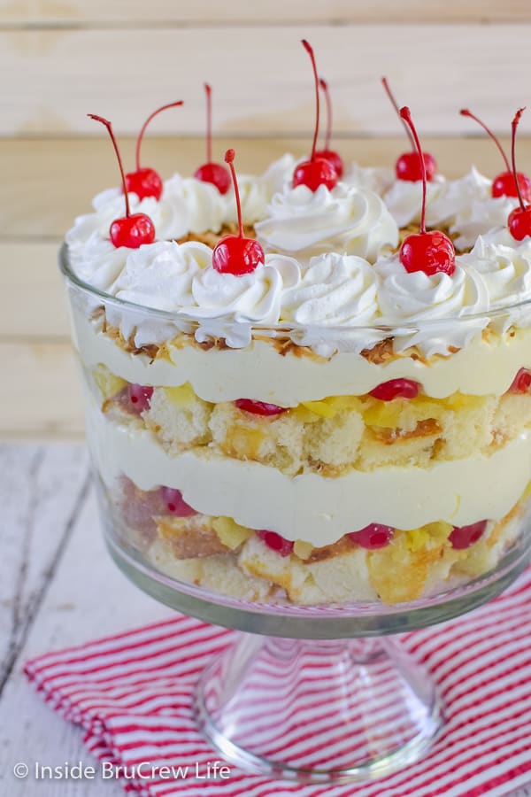 Pina Colada Cake Trifle - pineapple cake, no bake coconut cheesecake, and fruit layers make this cake trifle a tropical dessert that everyone will go crazy for! #pinacolada #coconut #trifle #nobakecheesecake #cakemix #caketrifle