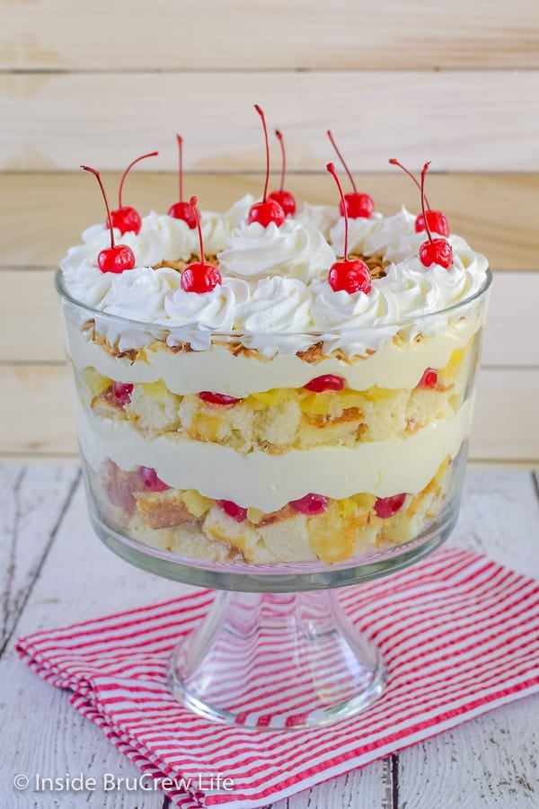 Pina Colada Cake Trifle - layers of pineapple cake, no bake coconut cheesecake, and fruit makes this tropical hit with everyone. Try this easy recipe for summer parties! #pinacolada #coconut #trifle #nobakecheesecake #cakemix #caketrifle