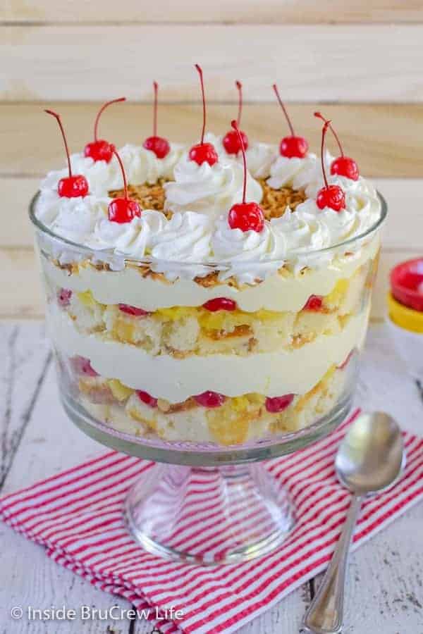 Pina Colada Cake Trifle - layers of cake, fruit, and no bake cheesecake makes this a must make dessert. Make this easy recipe and watch everyone devour it at summer picnics! #pinacolada #coconut #trifle #nobakecheesecake #cakemix #caketrifle 