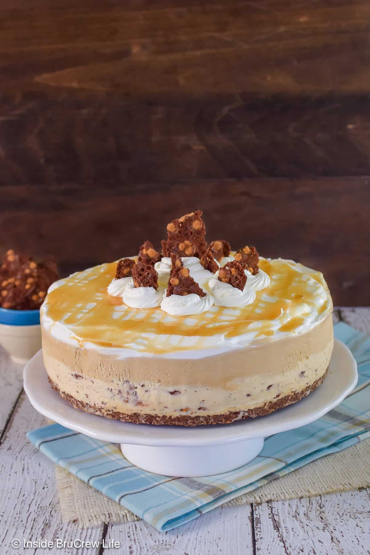 An entire salted caramel ice cream cake with cool whip and caramel on top.