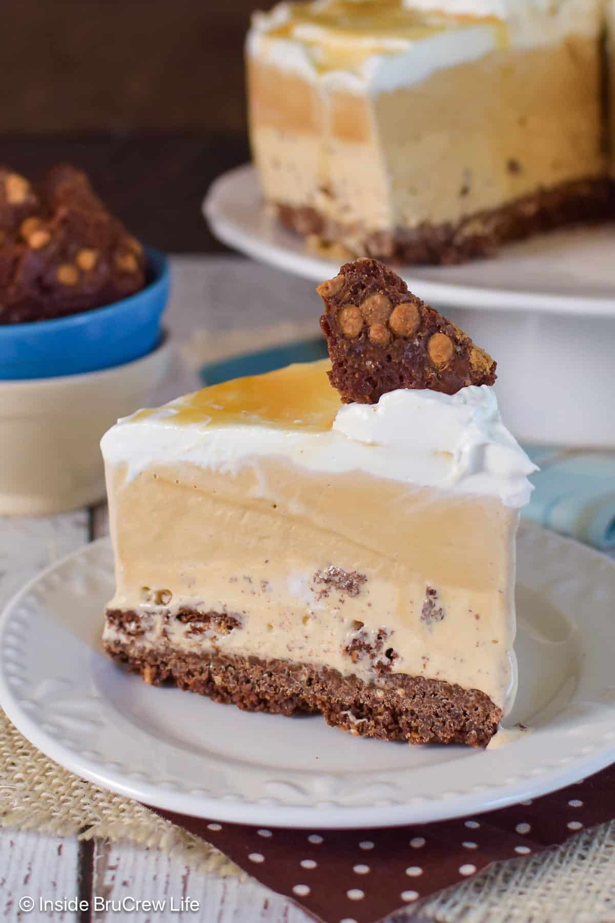 A slice of salted caramel ice cream cake on a white plate.