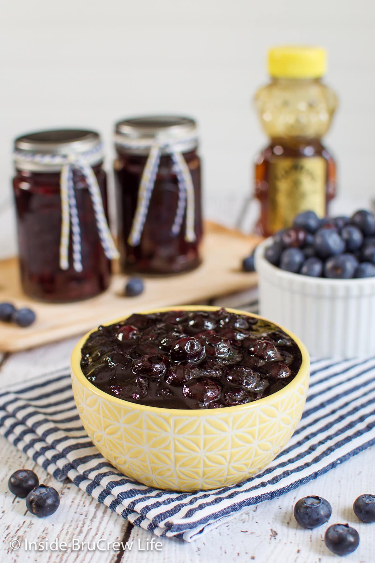A yellow bowl filled with a homemade blueberry topping.