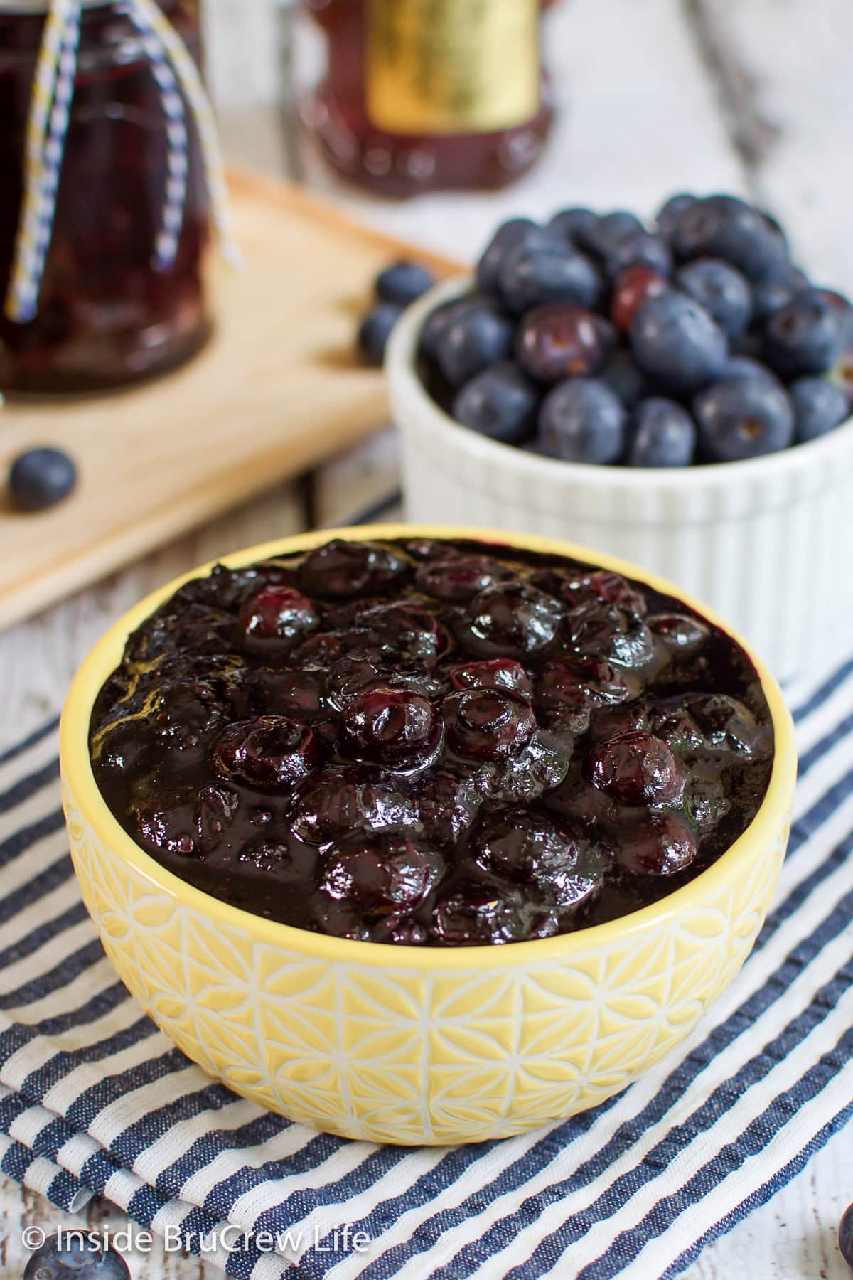 A yellow bowl filled with blueberry sauce.