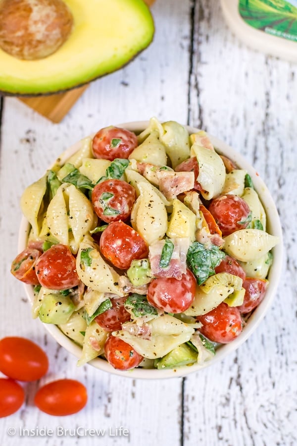 Overhead picture of a white bowl on a white background filled with ranch BLT pasta salad