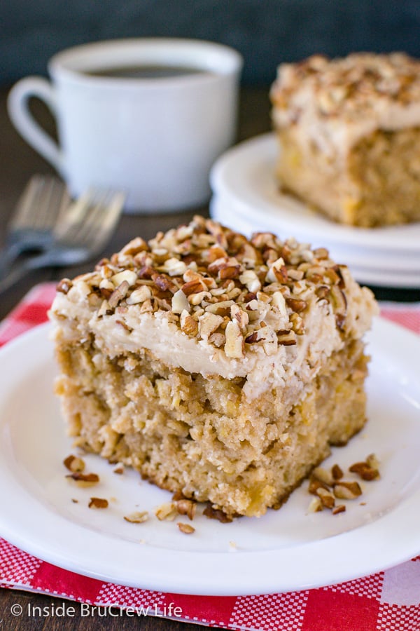 Two white plates with pieces of apple praline cake on them and a coffee cup behind 