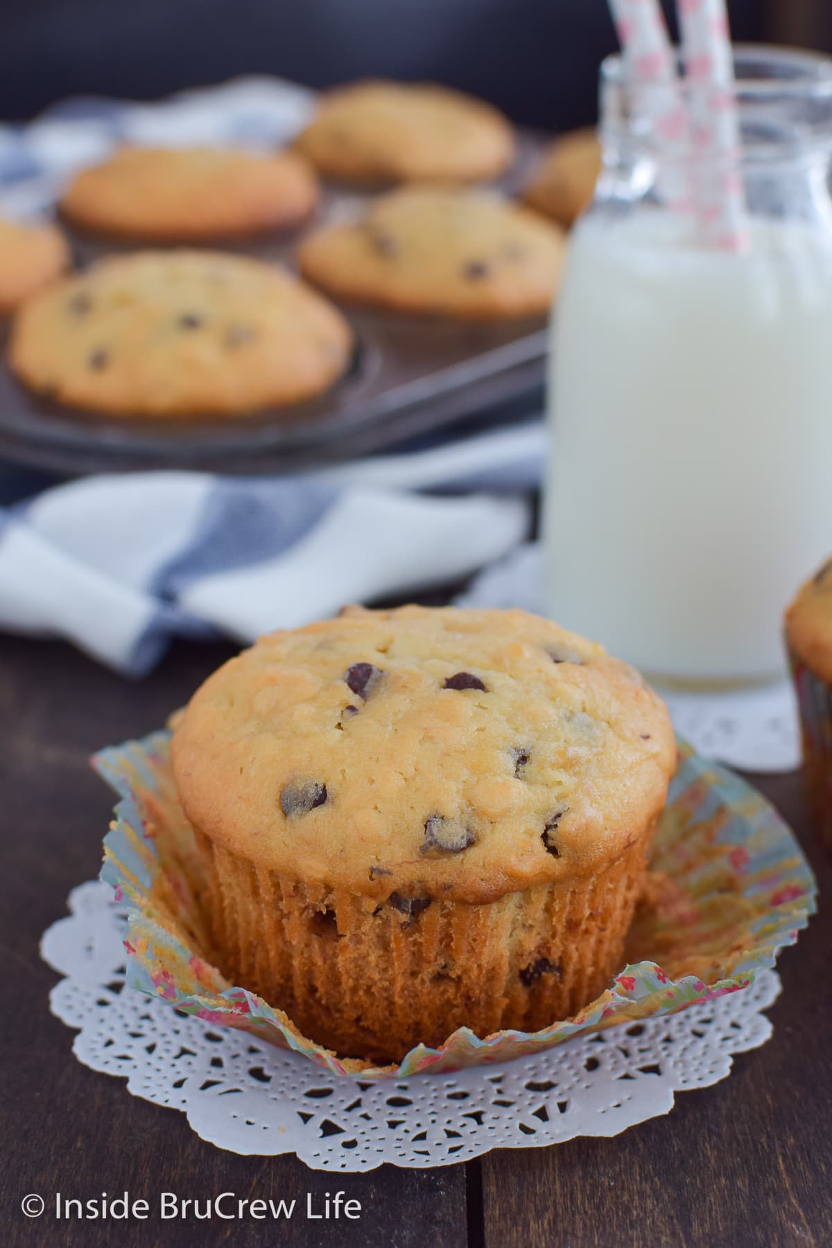 A fluffy banana muffin with chocolate chips on a paper liner.