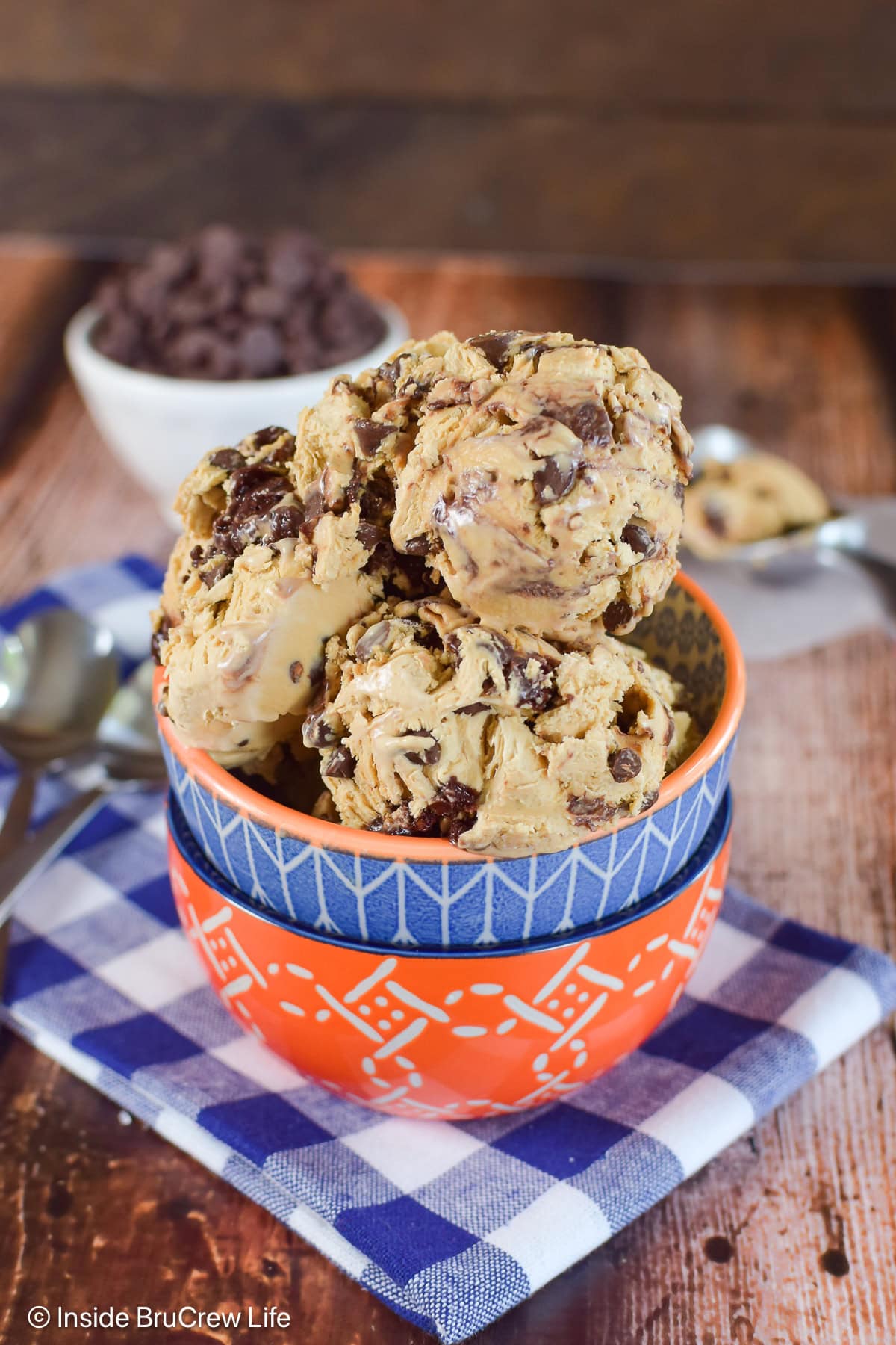 Scoops of brownie batter ice cream in a stack of bowls.