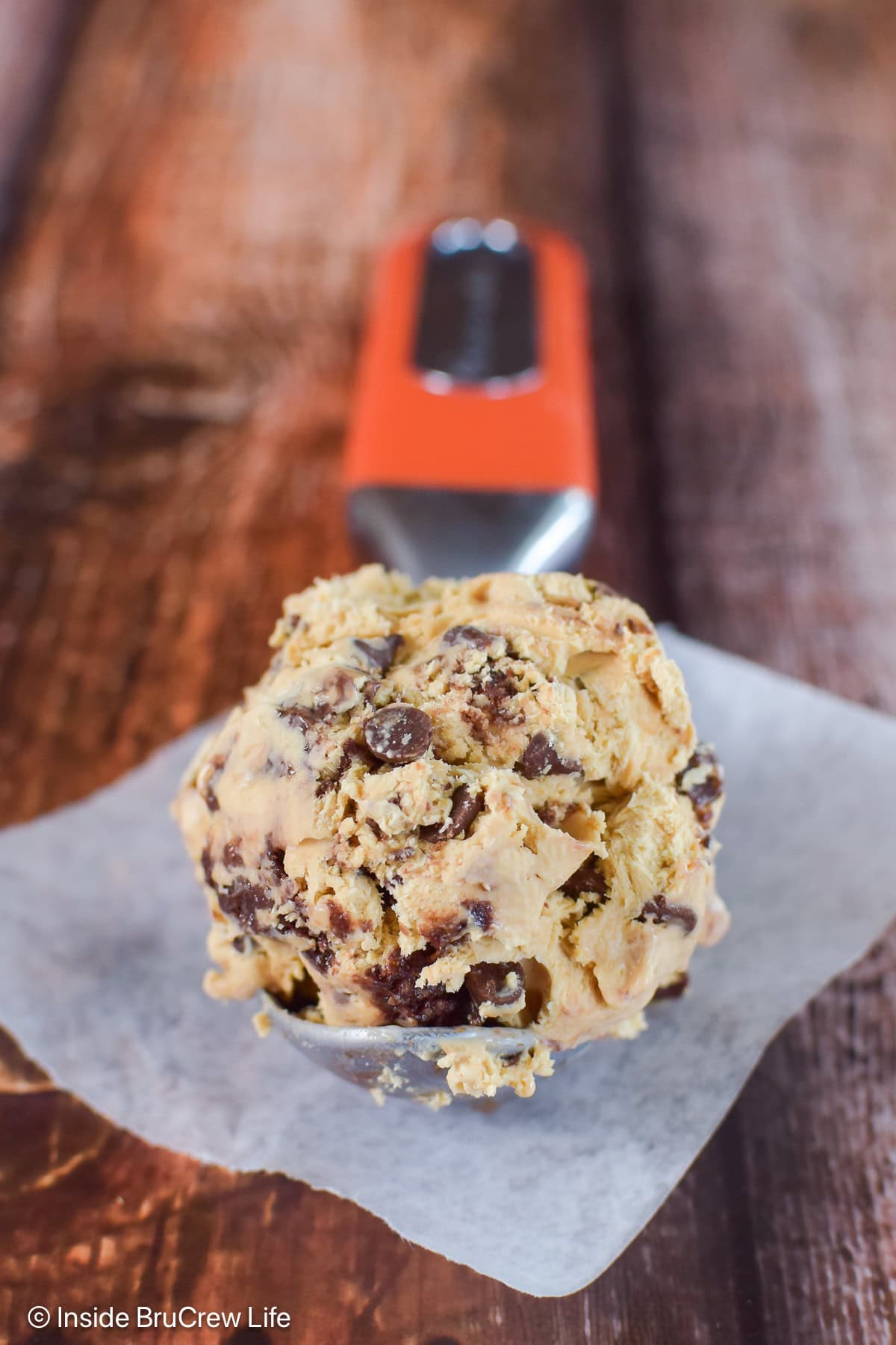 A scoop of coffee chip ice cream with brownie batter on a spoon.
