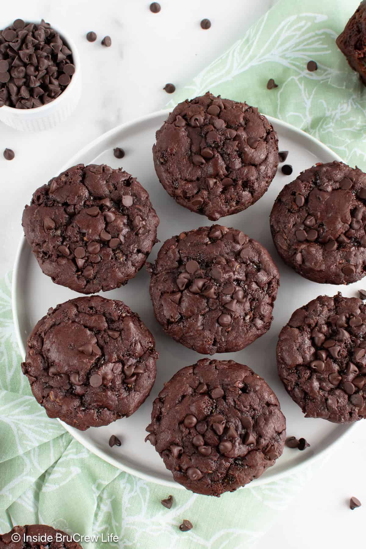Overhead picture of double chocolate muffins on a white plate.