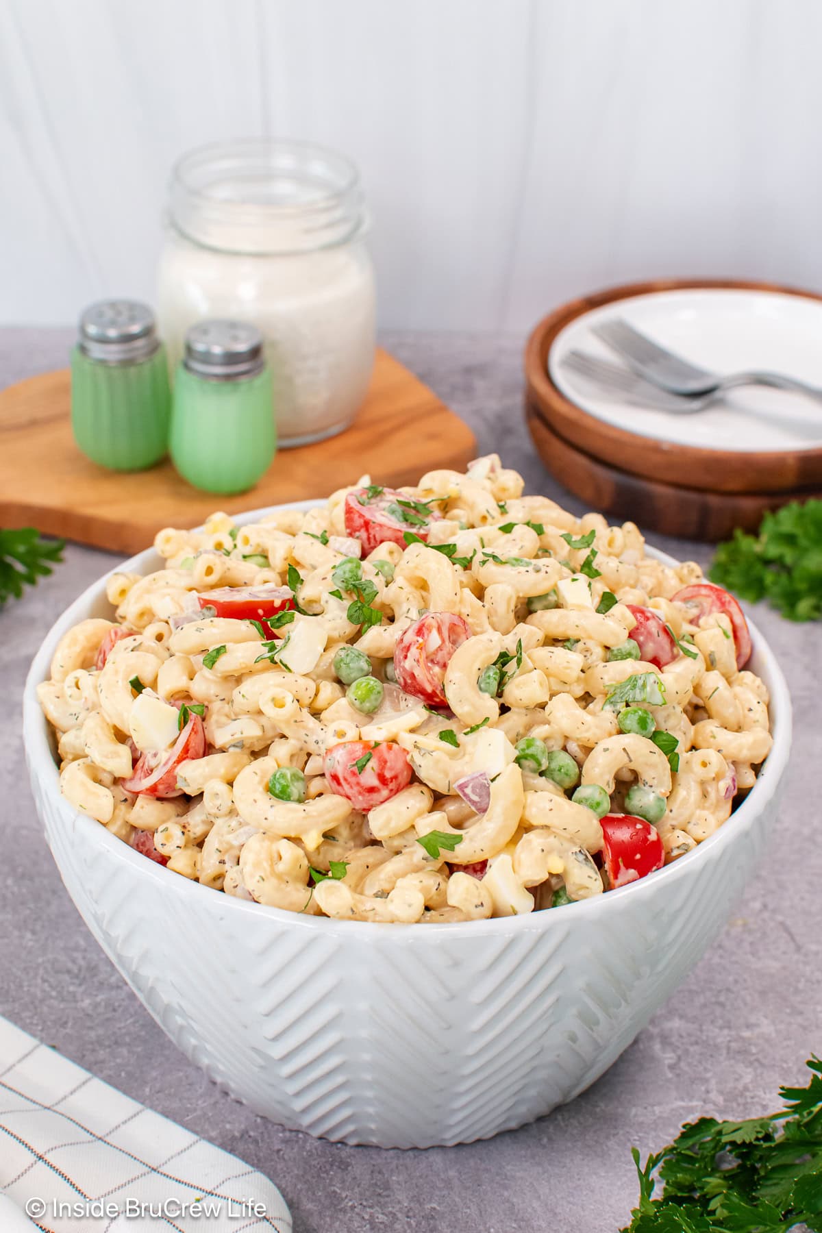 A white bowl of classic macaroni salad with ranch dressing.