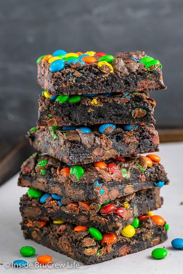 Six M&M's brownies stacked on top of each other on a tray.