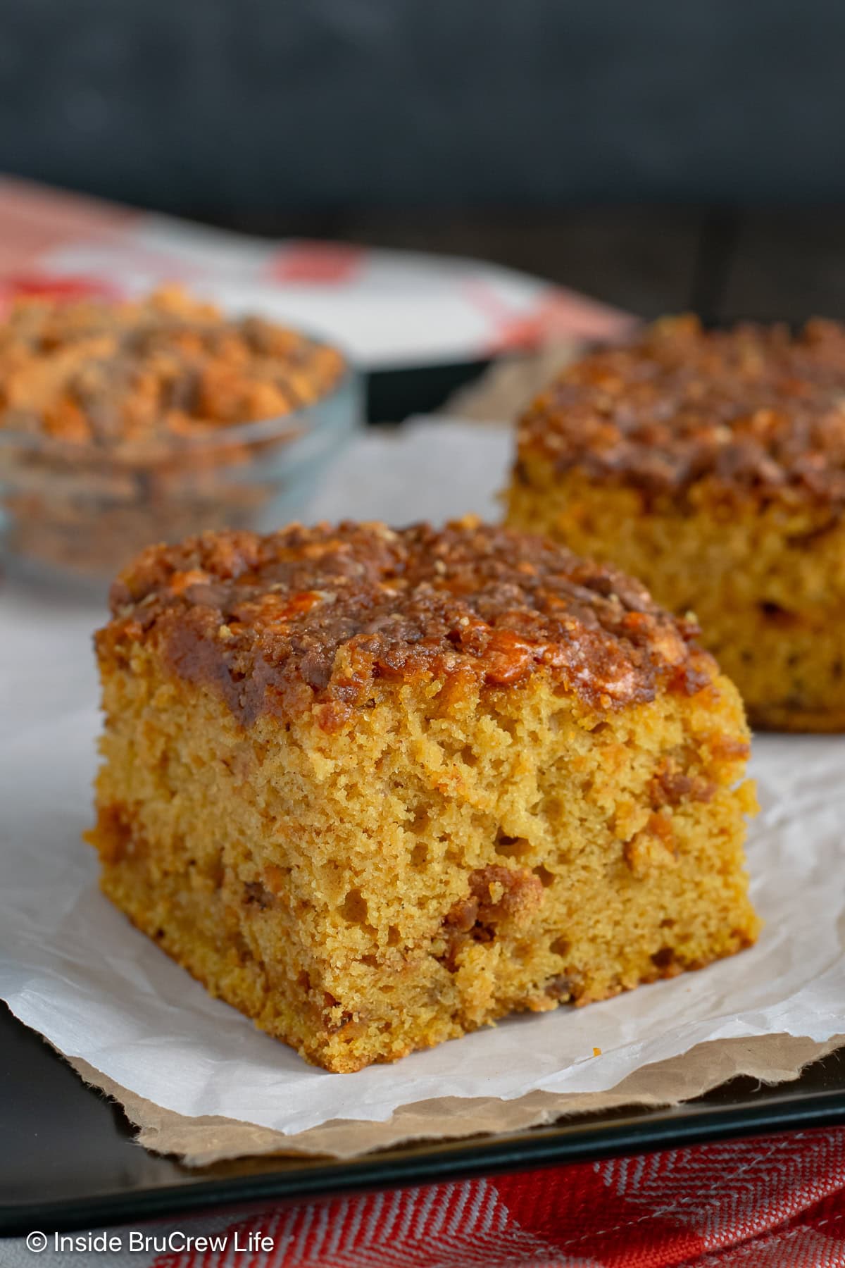 A slice of peanut butter pumpkin cake on parchment paper.