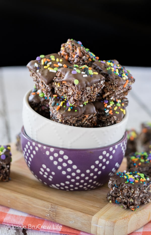 Two bowls stacked together and filled with no bake chocolate granola bar bites