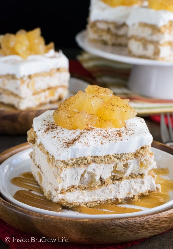 A white and brown plate with a square of apple icebox cake topped with apple pie filling on it