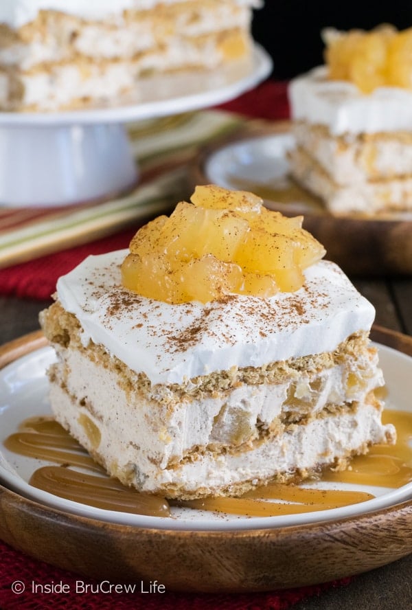 A square of cinnamon apple icebox cake topped with apple pie filling on a white and brown plate