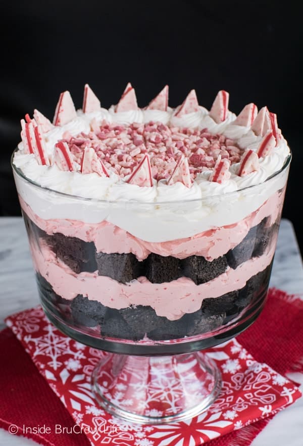 A large clear serving bowl with layers of Peppermint Brownie Trifle.