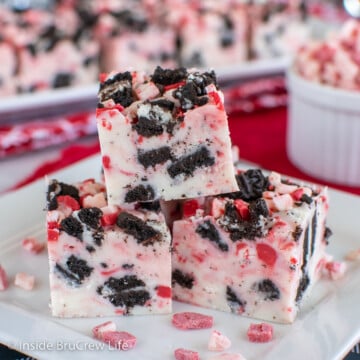 Squares of peppermint cookie fudge on a white plate.