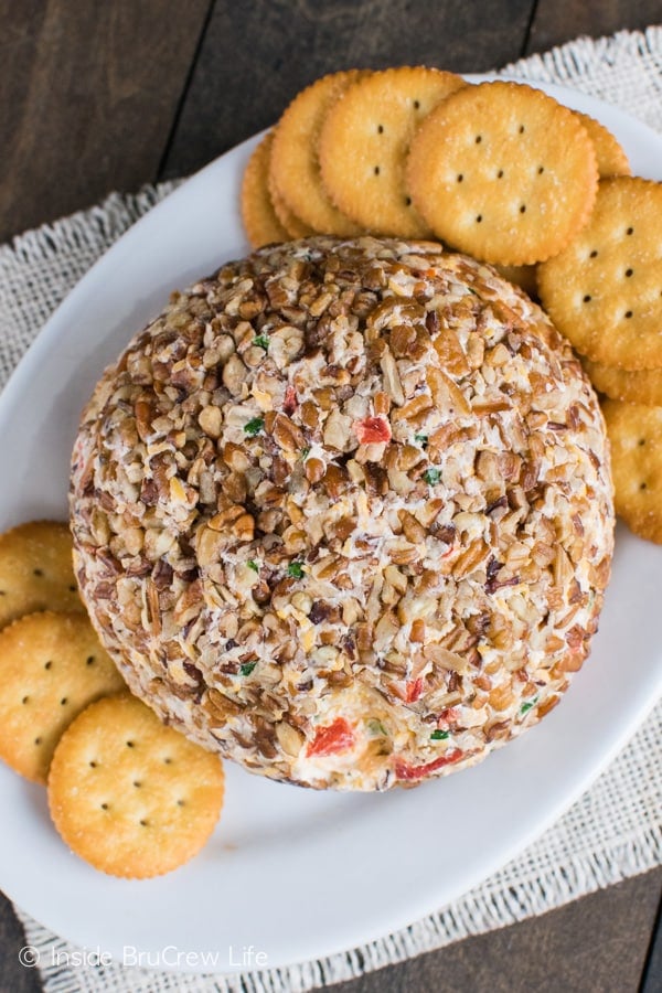 Overhead picture of a cheese ball with crackers on a plate.